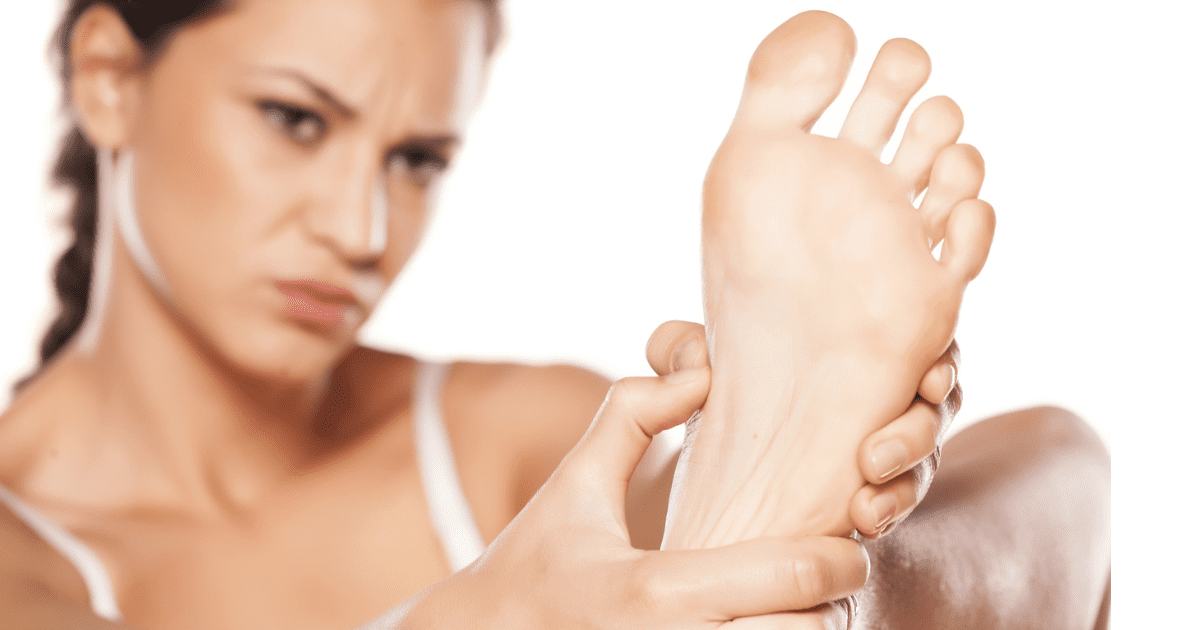 Woman Holding Painful Foot